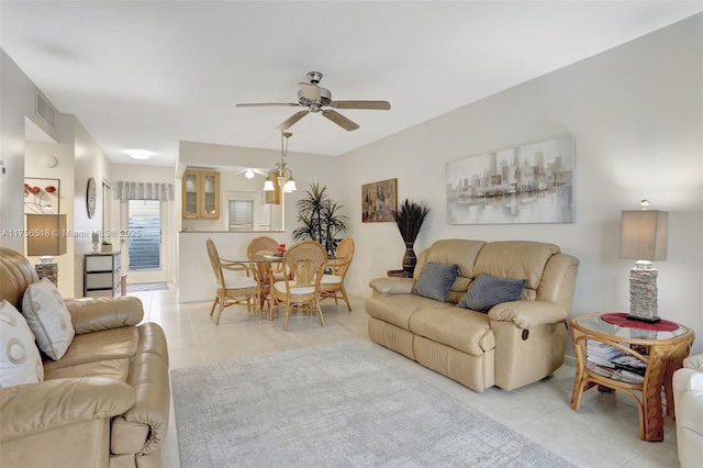 living area with light tile patterned floors, visible vents, and a ceiling fan