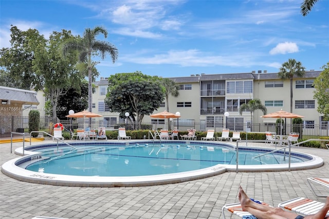 view of pool featuring a patio and fence