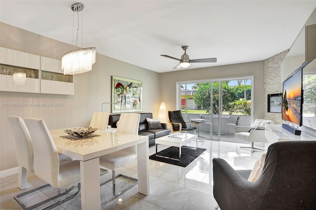 living room featuring ceiling fan with notable chandelier