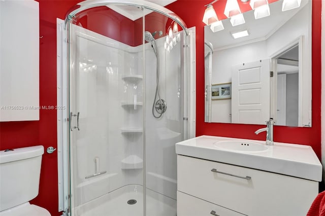 full bathroom with vanity, toilet, and a shower stall