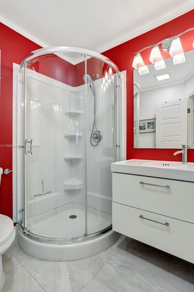 bathroom with toilet, a stall shower, and vanity