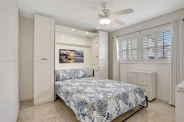 bedroom with ceiling fan and baseboards