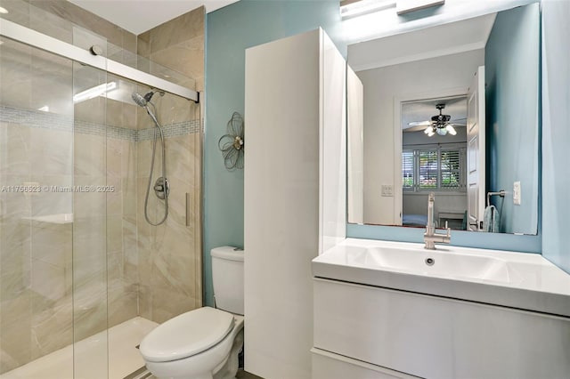 ensuite bathroom with vanity, ceiling fan, a shower stall, toilet, and connected bathroom