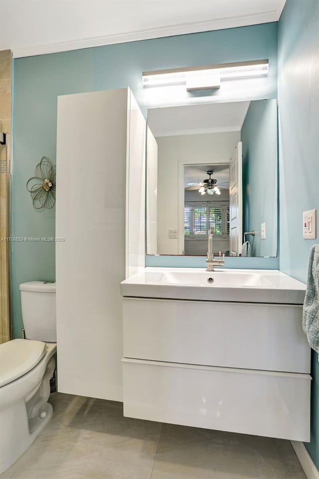 bathroom featuring vanity, ornamental molding, toilet, and ceiling fan