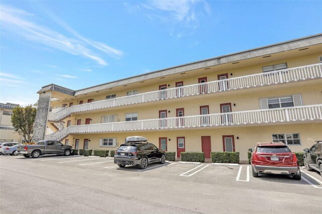 view of building exterior with uncovered parking