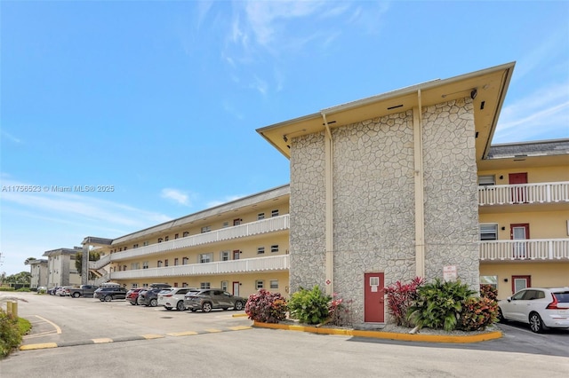 view of building exterior featuring uncovered parking