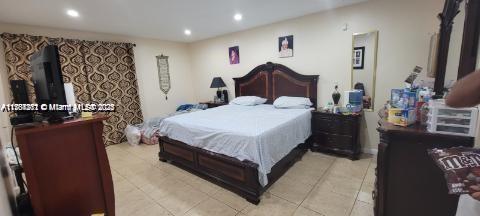 bedroom featuring light tile patterned flooring and recessed lighting