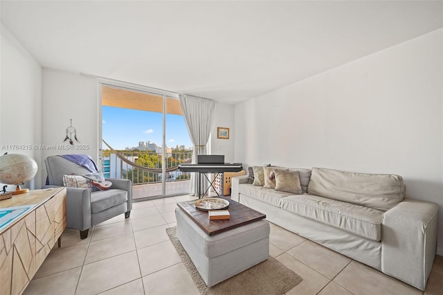 living room featuring light tile patterned floors, expansive windows, and a view of city