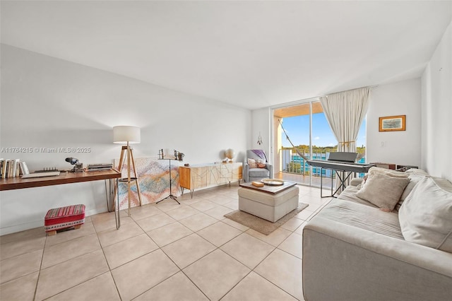 living room with light tile patterned floors, baseboards, and expansive windows