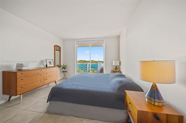 bedroom featuring light tile patterned flooring and access to outside