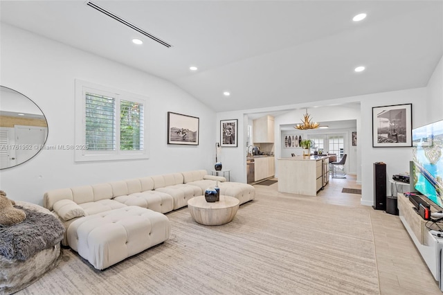 living area with light wood-type flooring, visible vents, lofted ceiling, and recessed lighting