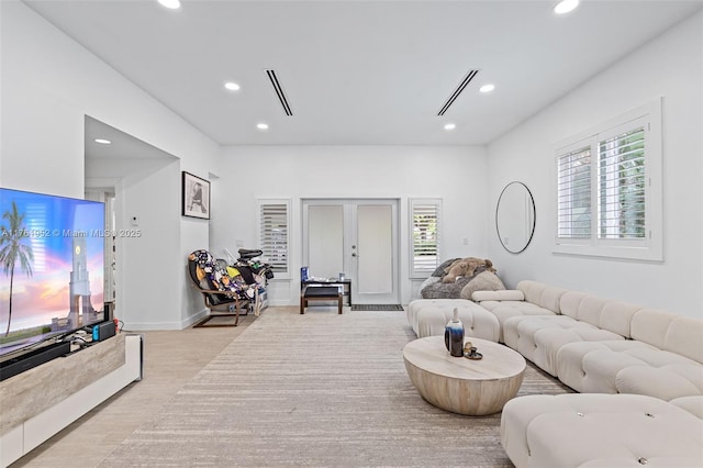 living room featuring french doors, wood finished floors, plenty of natural light, and recessed lighting