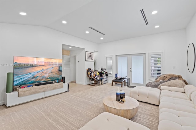 living room featuring french doors, visible vents, lofted ceiling, and recessed lighting