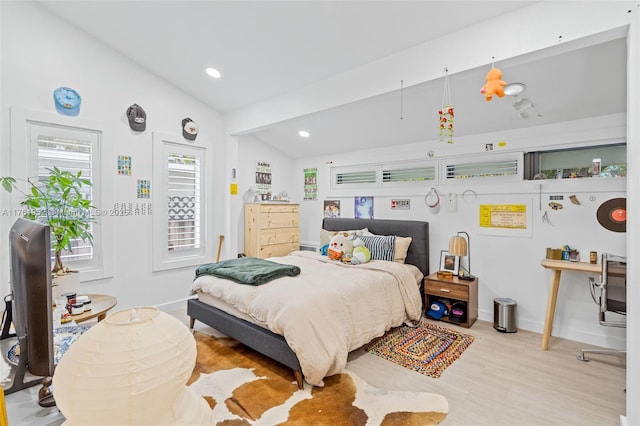 bedroom with baseboards, lofted ceiling, wood finished floors, and recessed lighting