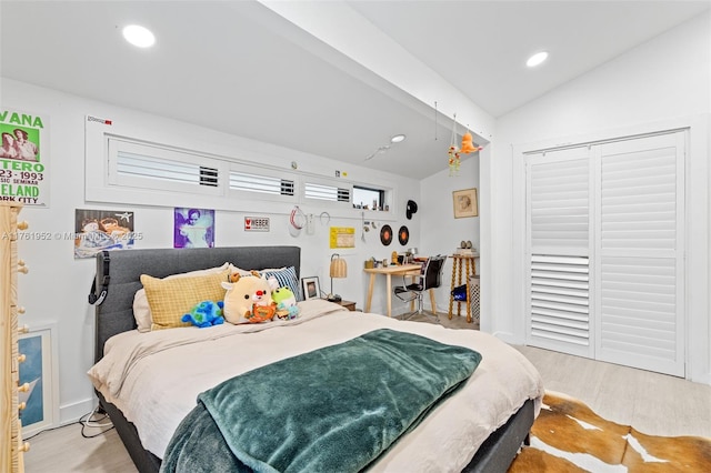 bedroom with wood finished floors, vaulted ceiling, and recessed lighting