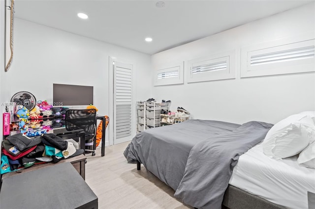 bedroom with light wood finished floors and recessed lighting