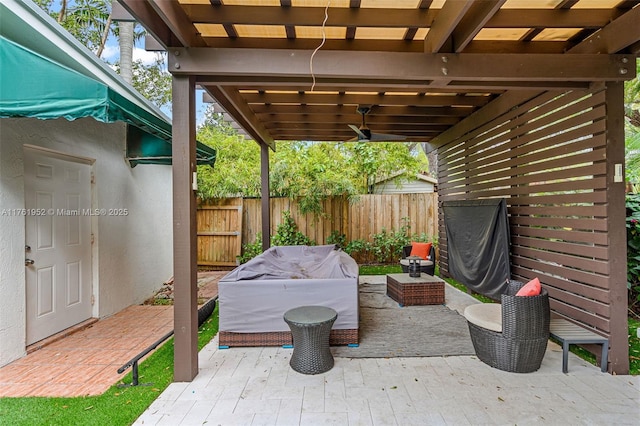 view of patio with ceiling fan, fence, and a grill