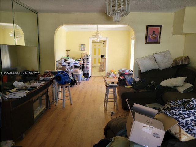 living area featuring wood finished floors and arched walkways