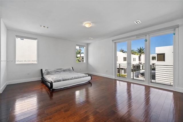 bedroom with french doors, wood-type flooring, baseboards, and access to outside