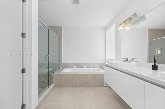 bathroom featuring tile patterned flooring, visible vents, a garden tub, a stall shower, and vanity