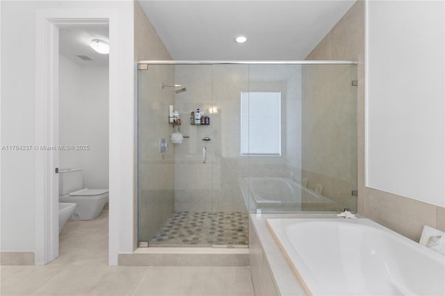 full bath featuring toilet, a shower stall, a garden tub, and a bidet