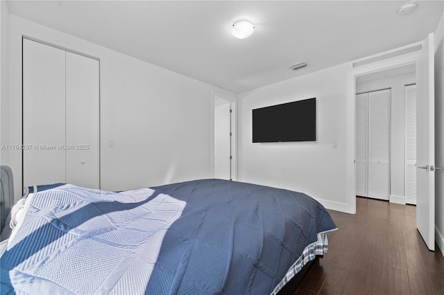 bedroom with visible vents, baseboards, a closet, and dark wood-style flooring