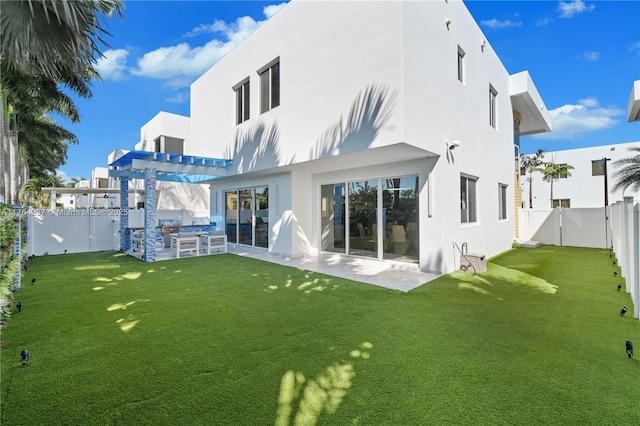 back of property with a patio area, a yard, a fenced backyard, and stucco siding