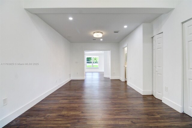 interior space with dark wood-style floors, visible vents, recessed lighting, and baseboards