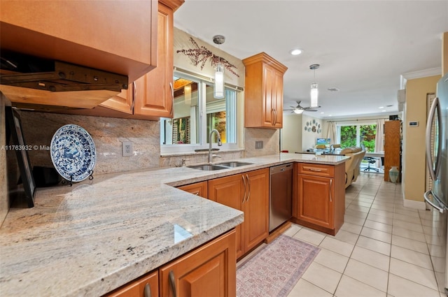 kitchen with a sink, decorative light fixtures, stainless steel appliances, a peninsula, and light tile patterned floors