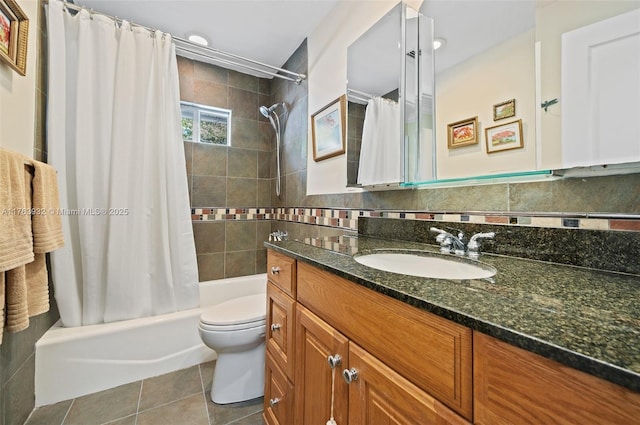 bathroom with tile patterned flooring, toilet, vanity, shower / bath combo, and tile walls