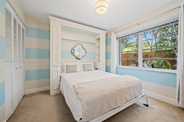 bedroom featuring light carpet, a closet, and baseboards