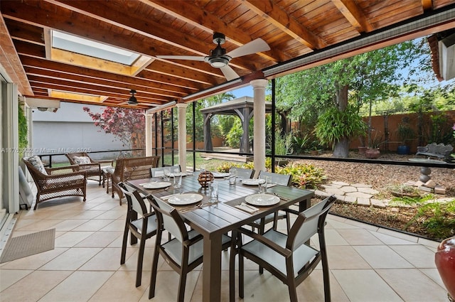 view of patio featuring an outdoor living space, ceiling fan, fence, a gazebo, and outdoor dining space