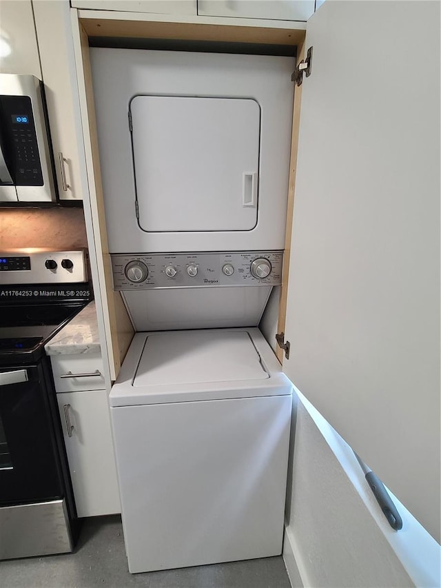 washroom with laundry area and stacked washing maching and dryer