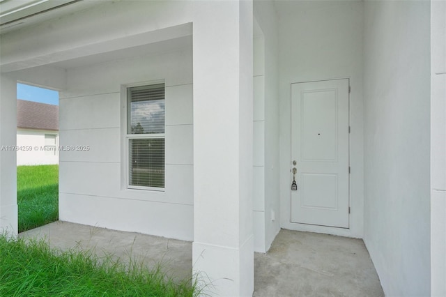 property entrance with stucco siding