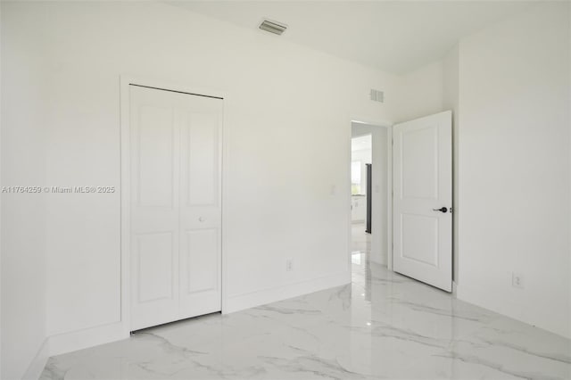 unfurnished bedroom with visible vents, marble finish floor, and baseboards