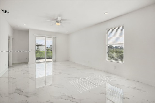 spare room with recessed lighting, a ceiling fan, visible vents, and marble finish floor