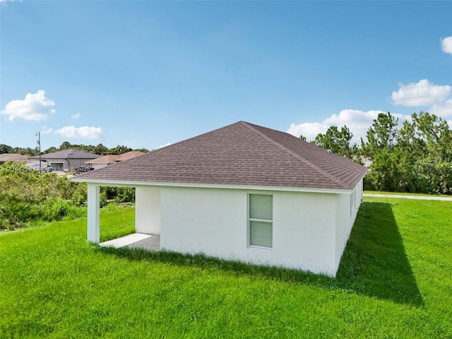 view of property exterior featuring a lawn, roof with shingles, and stucco siding