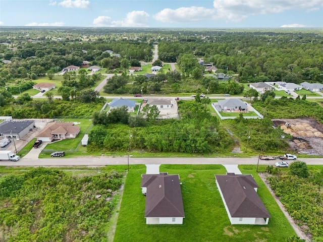 bird's eye view with a residential view and a wooded view