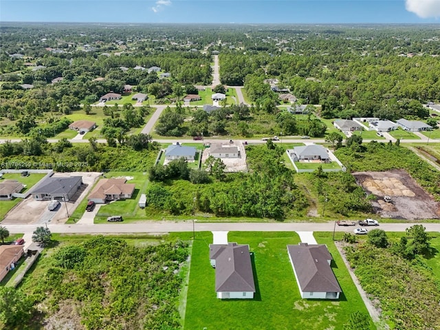 birds eye view of property featuring a residential view and a view of trees