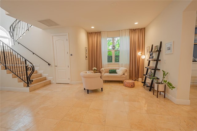 sitting room featuring stairway, recessed lighting, and baseboards