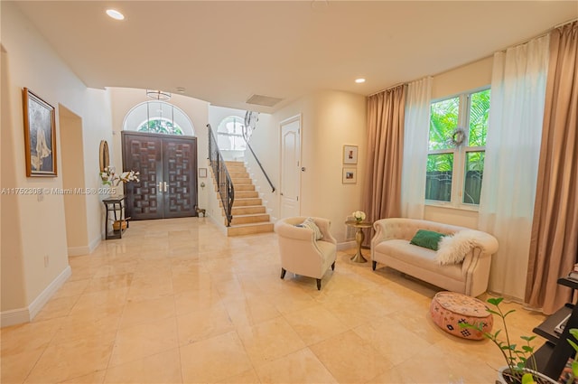 foyer featuring recessed lighting, stairs, and baseboards