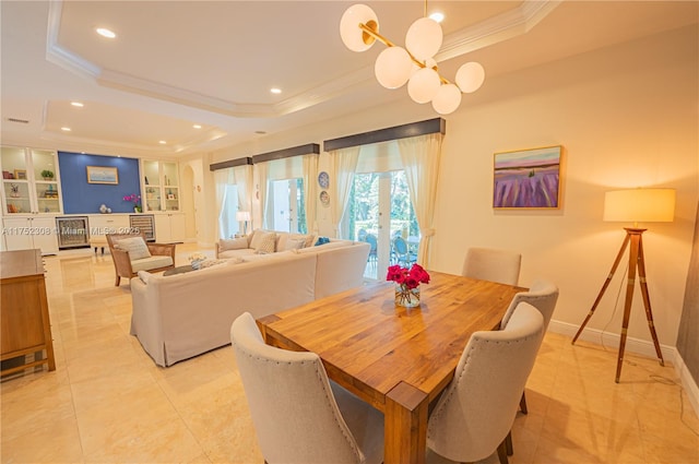 dining space featuring built in shelves, baseboards, recessed lighting, crown molding, and a raised ceiling