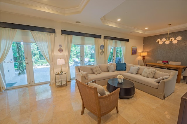 living room featuring a notable chandelier, french doors, a raised ceiling, and crown molding