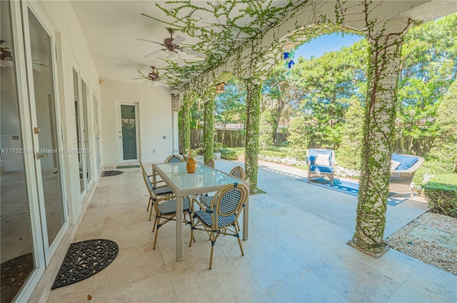 view of patio / terrace with outdoor dining area, a fenced backyard, and a ceiling fan