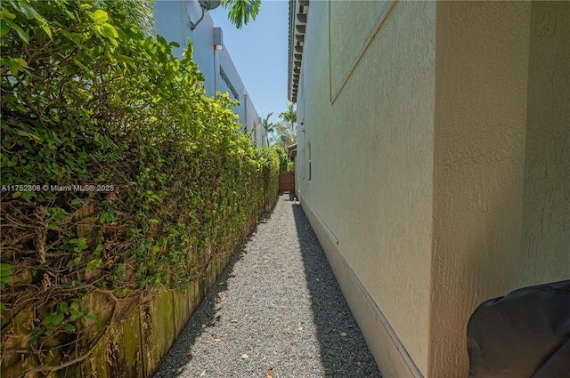 view of side of home featuring fence