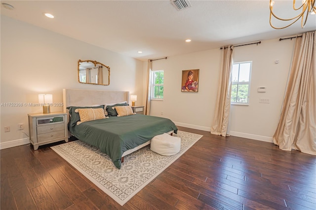 bedroom with dark wood-style floors, visible vents, baseboards, recessed lighting, and a chandelier