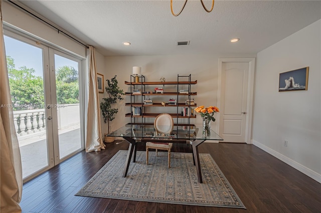 office featuring visible vents, a textured ceiling, wood finished floors, french doors, and baseboards