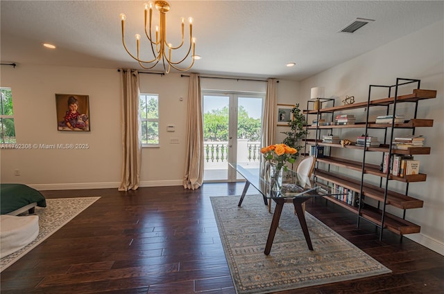 dining area with baseboards, visible vents, wood-type flooring, a textured ceiling, and a chandelier