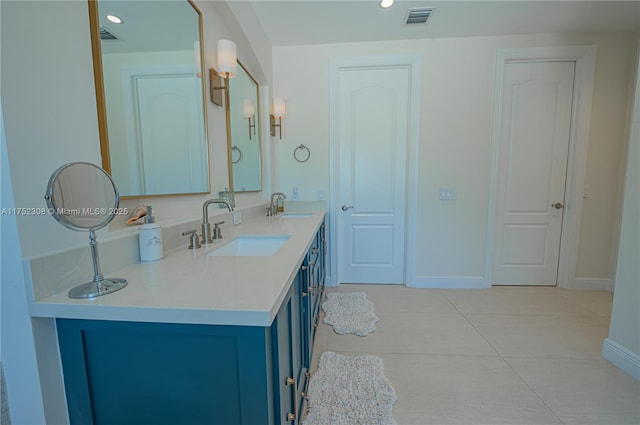 full bath featuring a sink, visible vents, baseboards, and double vanity