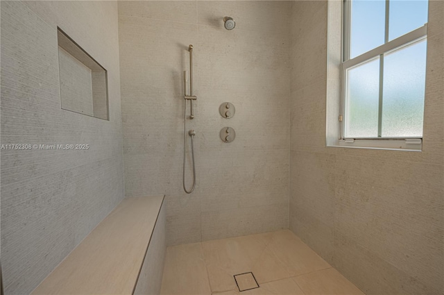 bathroom with a tile shower